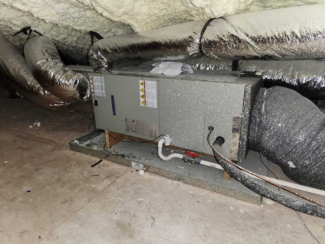 Attic-mounted HVAC air handler with sealed and insulated ductwork.