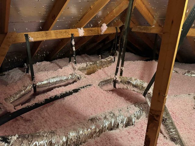 Even coverage of blown-in insulation throughout a residential attic.