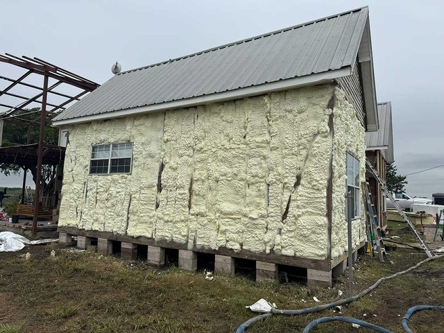 Spray foam insulation applied to exterior wall cavities during construction.