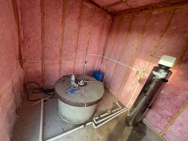 Spray foam insulation installed around an indoor mechanical equipment area.