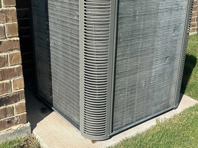 High-efficiency outdoor condenser installed on a level equipment pad.