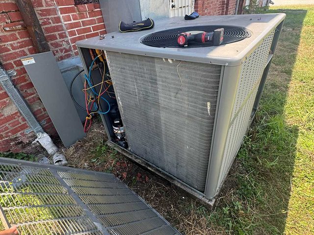 Outdoor air-conditioning condenser installed in a residential side yard.