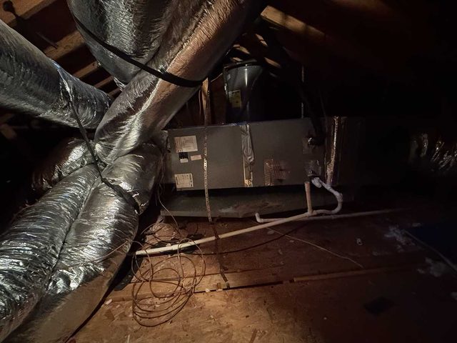 Attic air handler and duct system documented during HVAC service.