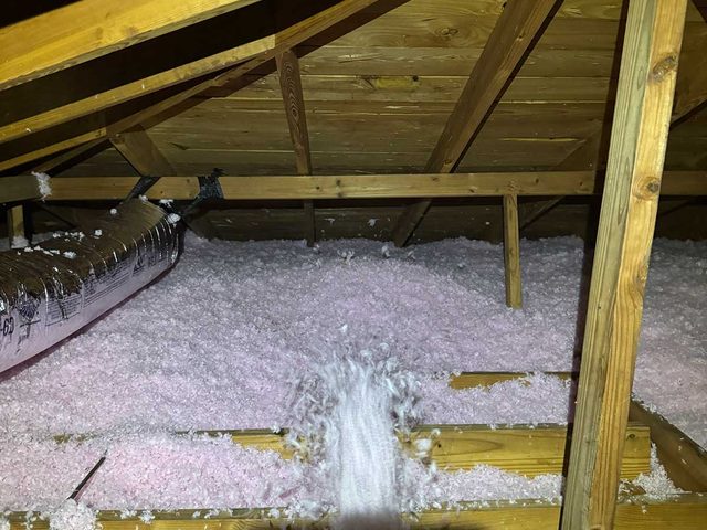 Fresh blown-in insulation installed across an attic floor.